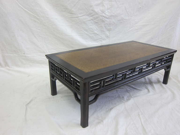 Exquisite Chinese coffee table, 19th century low table with faux bamboo carved wood apron and rattan top.  Color is more Eggplant then black or dark brown.