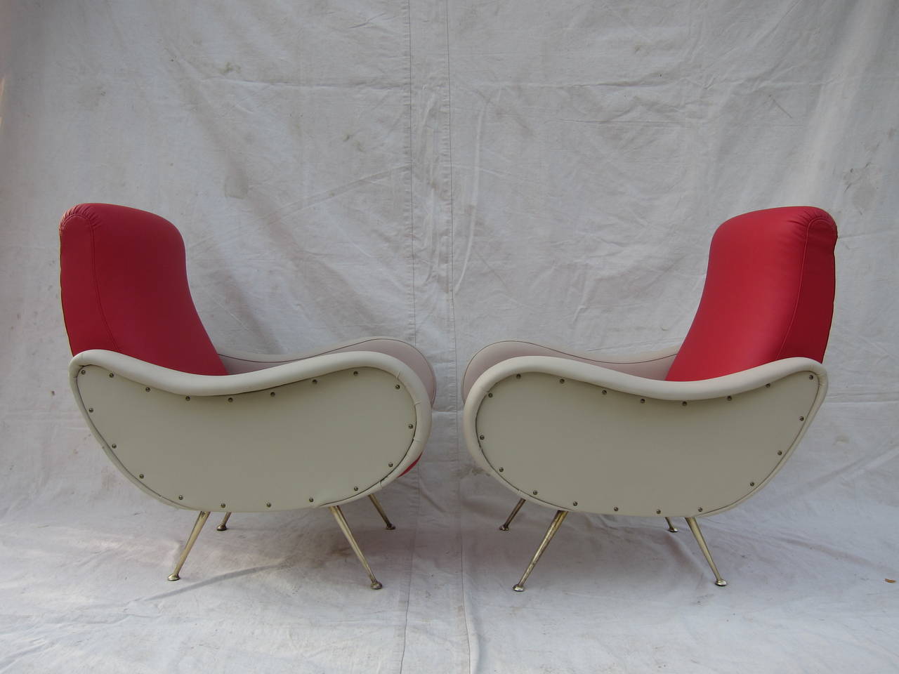 A sculpted pair of mid century Italian lounge chairs in the Style of  Marco Zanuso.  In very good to excellent condition with fine detailed upholstery.  Extremely comfortable.   
