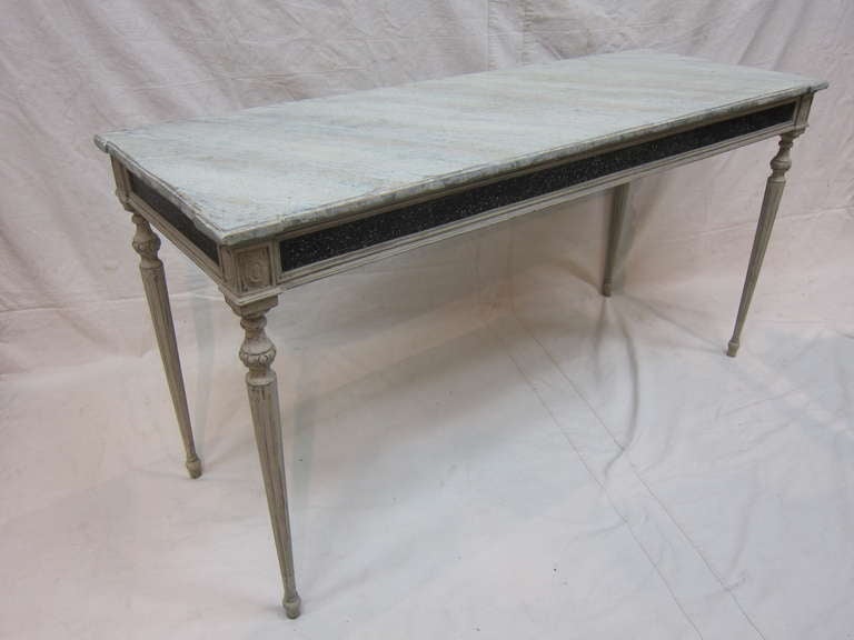 A 19th century Gustavian Console Table.  Tall Gustavian Console Table with Faux painted Marble top having a marvelous speckled apron detail.  Tall fluted turned narrow legs set to Pine frame.  The top displays enhanced large corners on all four