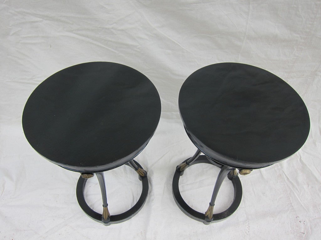 A Matched pair early 20th century Neoclassical Black Lacquered Side tables. Wonderfully Shaped articulated legs on circular struts.  Priced individually. 
Very good condition.  