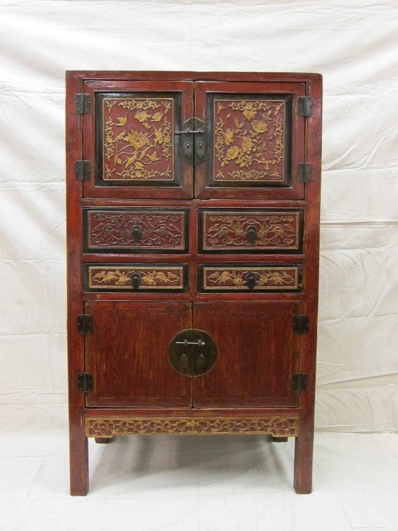 A beautifully decorated carved and gilded 19th century, Chinese cabinet. Great storage or dry bar, two compartments large enough for bottles with four drawers. circa 1870.