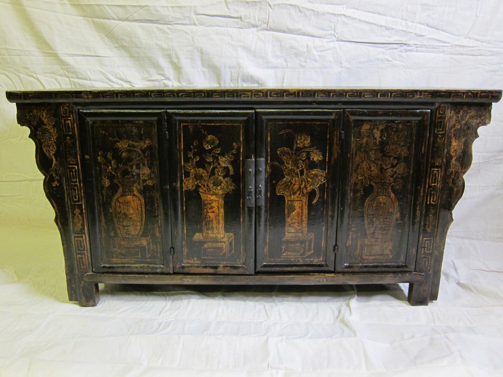 19th century Chinese painted sideboard with bifolding doors, four drawers inside, and cusped spandrels. Beautiful piece with warm tones.