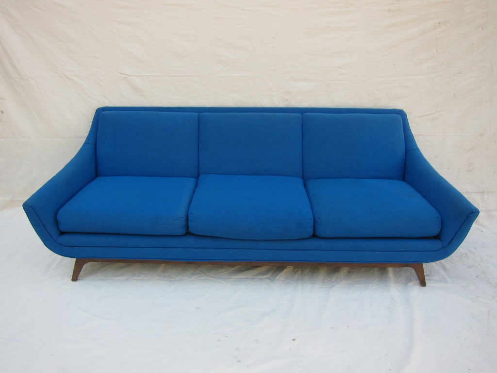 A wonderful sculpted sofa designed by Adrian Pearsall for Craft Associates.  The walnut base has been restored, needs updated upholstery.  Price includes complete restoration and reupholstery of the sofa with Customers Fabric,(COM requirement 18