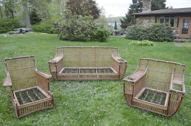 Four piece, large scale stick wicker set by Niagara Reedcraft, Inc. of Niagra Falls, NY. in faded original finish.  Large scale and sturdy with hard wood frames.