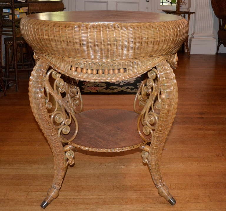 Ornate Victorian table with quarter sawn oak top and lower shelf in natural finish.