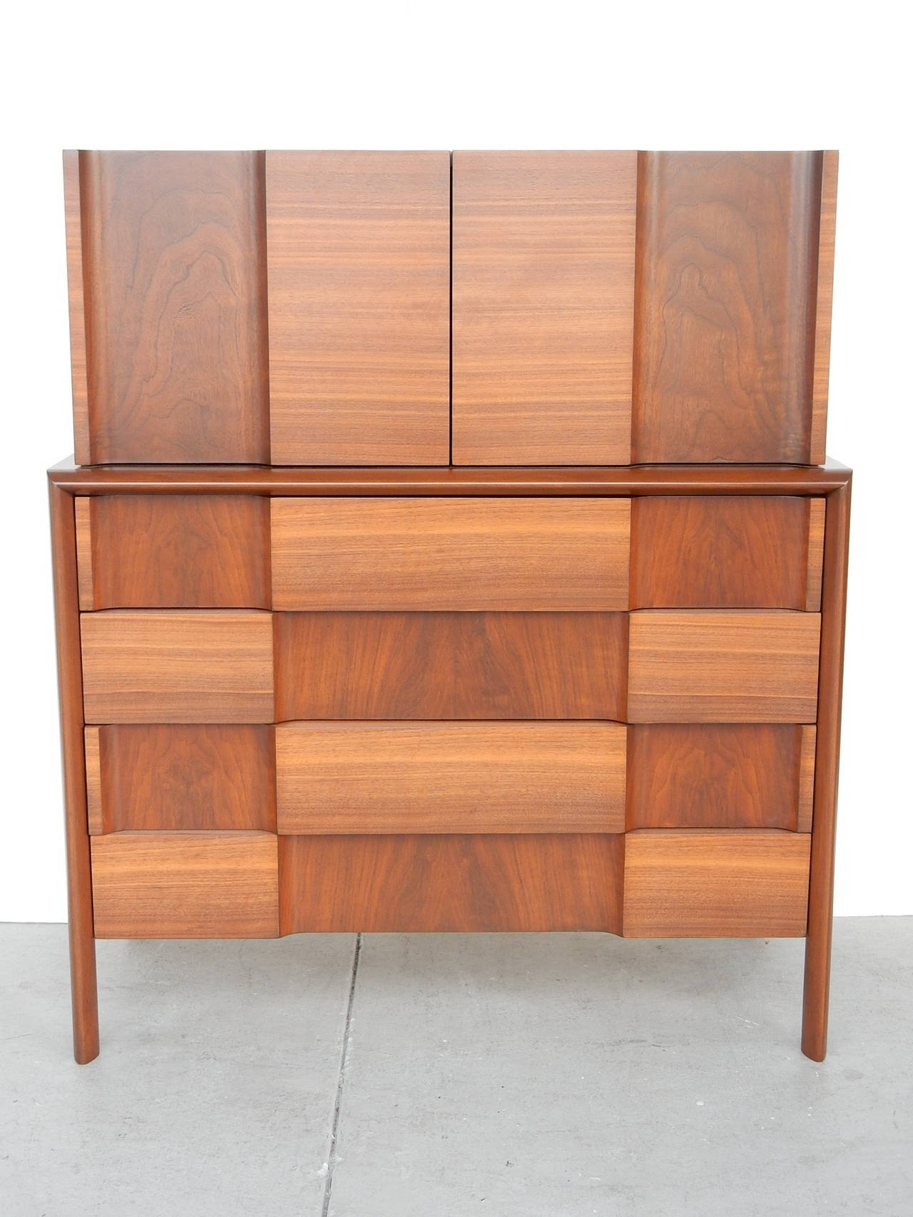 A walnut highboy by Edmond Spence. Lots of storage and great looking. Could even be used as a bar. We have more pieces from this suite.