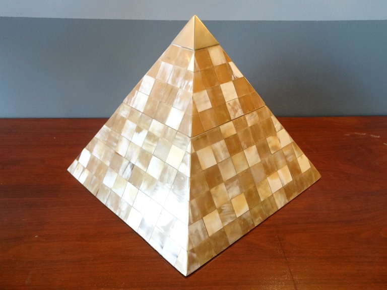 A large box in the shape of a pyramid, finished in pieces of horn and a brass pinnacle.