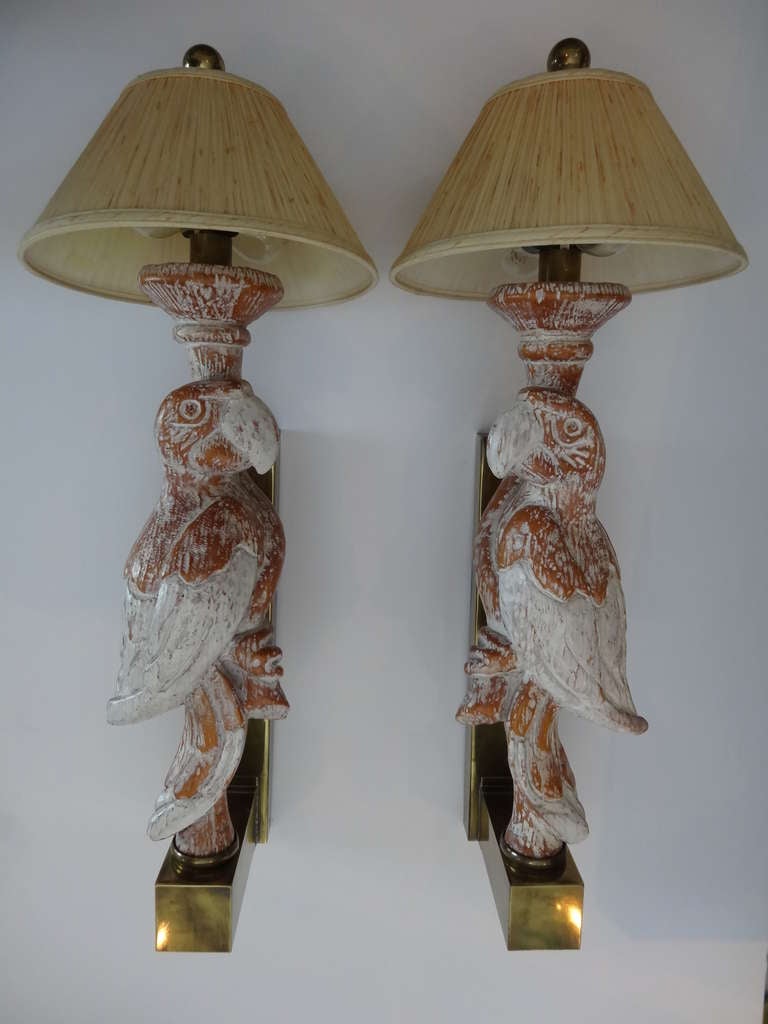 A very large pair of sconces, the carved wood parrots mounted on brass bases. These are bigger than life size parrots.