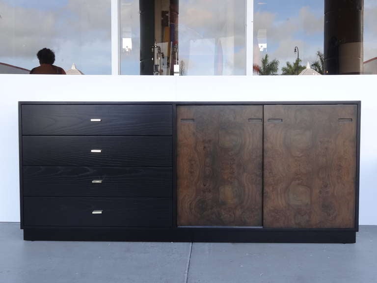 A stunning credenza by Harvey Probber. 4 Exposed drawers with solid brass handles, there are also 8 more drawers behind the 2 sliding doors.