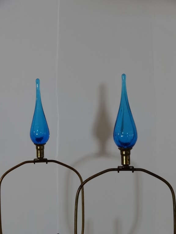 Amazing pair of Blenko lamps. Intense blue color. Retain the original matching finials. The harps are adjustable