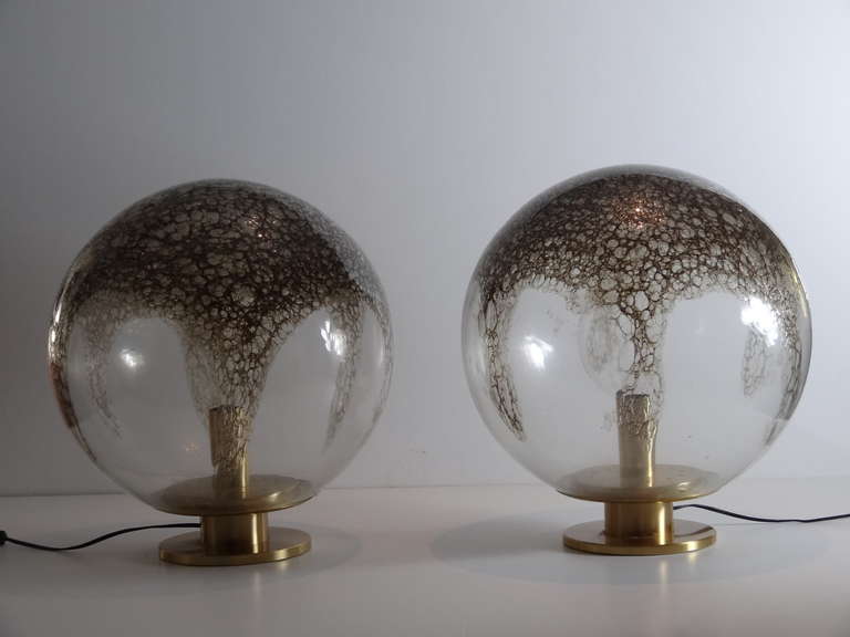 A very large pair of Murano globes. Simple geometric shape, spectacular technique. The large thick globes are mounted on brass bases.