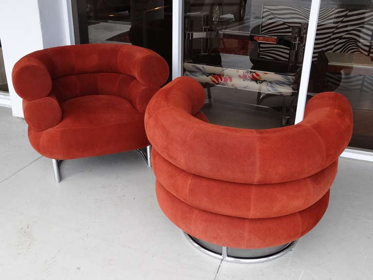 A pair of Eileen Gray Bibendum chairs by Classicon. Signed and numbered, one is # 111 and the other one is # 166.  Original rust suede upholstery on chrome bases. Super comfortable.