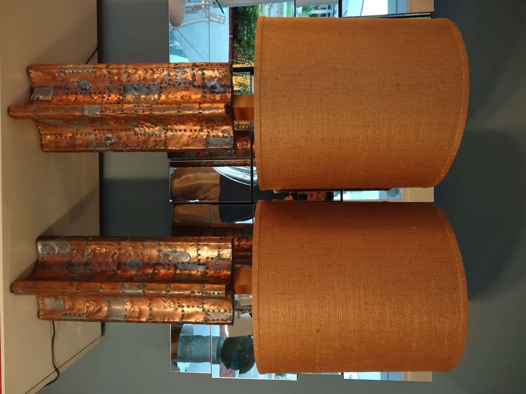 A pair of very large studio lamps. They are done in the copper patchwork technique with pewter splatters. Expertly done with intricate yet balanced patchwork design.  Both raw and refined. Retain the original burlap shades.