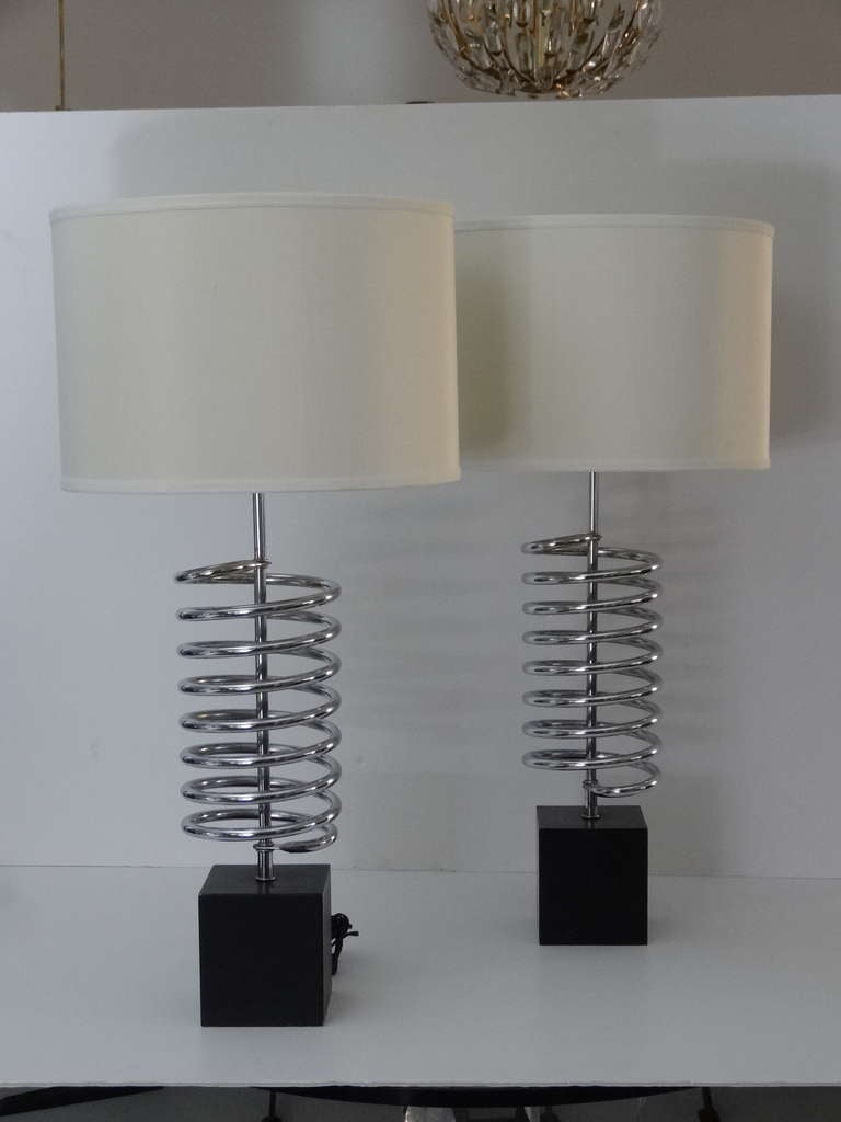 A pair of handsome lamps by Laurel. Black enamel metal base with a large coil design.