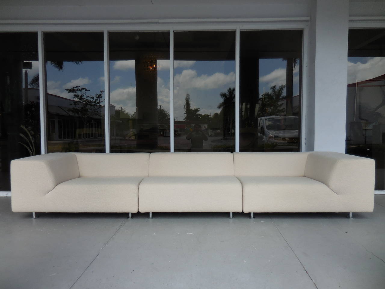 A Minimalist design sofa by Cassina. Polished aluminum legs and original nubby upholstery. Super comfortable.