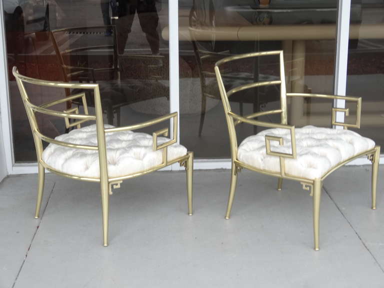A pair of brass armchairs with Greek key design by Mastercraft.
