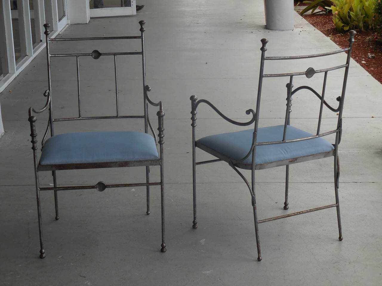 Exquisite pair of chairs. hand-forged steel. Striking sculptural elements. Signed on back.