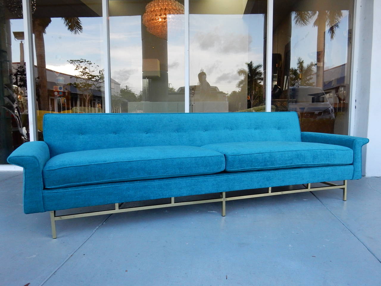 Stunning sofa. Classic 1960s design, with a low profile and polished brass bases. Super comfortable/