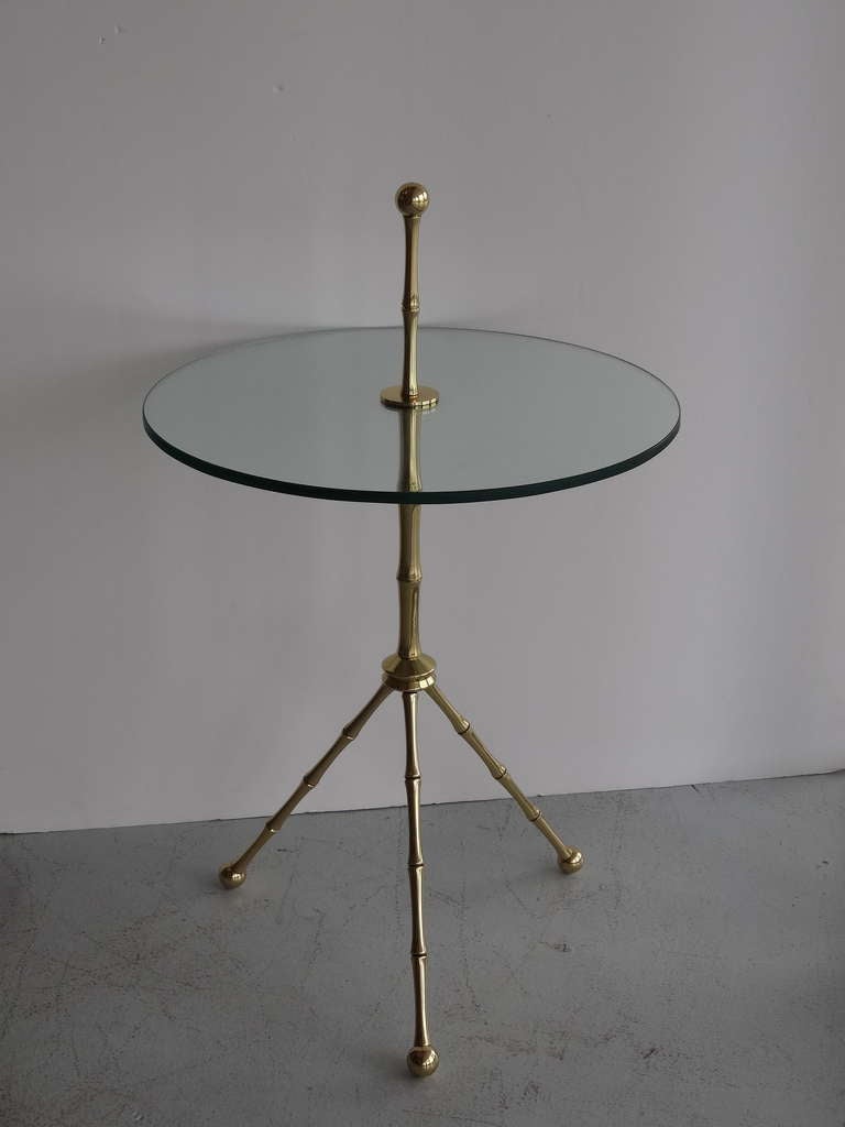 A very practical and beautiful table. Solid brass with a round glass top.