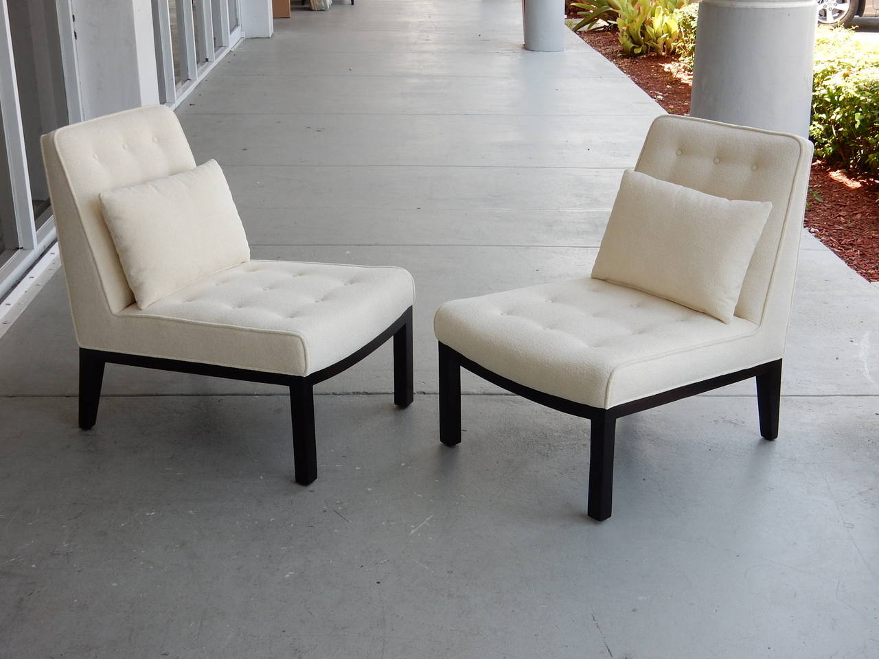 Chic pair of chairs by Edward Wormley for Dunbar. Wood frame and upholstered seats and backs. Lots of subtle sophisticated detail. Note the trapezoid back that also curves at the top, as well as the curve at the front of the seats. Very comfortable