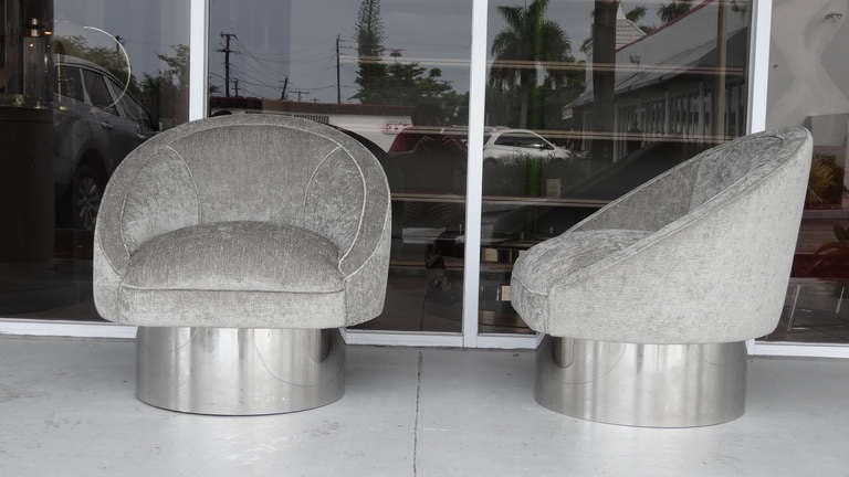 Handsome pair of 1970s swivel chairs. Clean profile. Mirror polished stainless steel bases. Very comfortable as well as great looking.