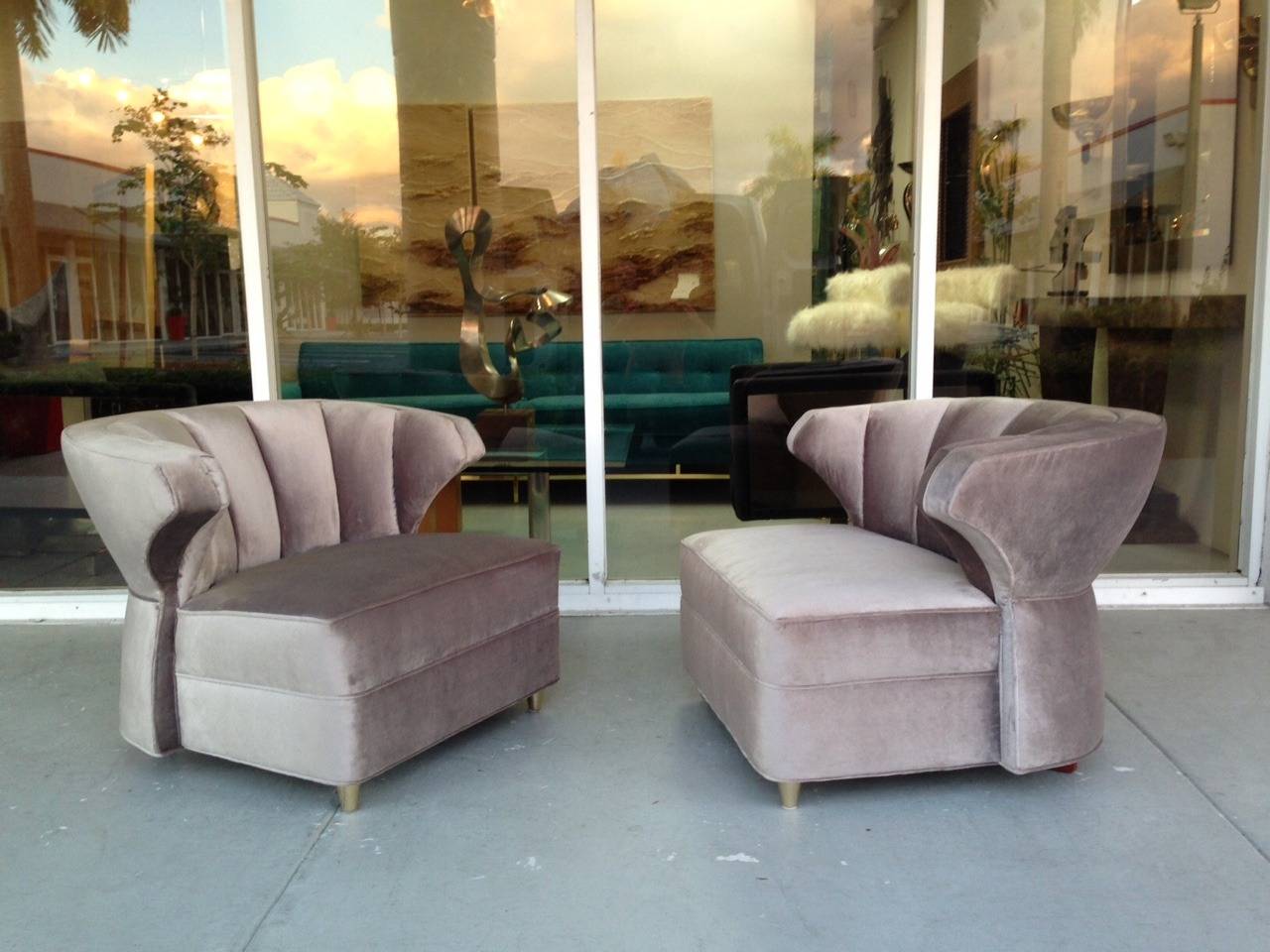 Beautiful pair of lounge chairs. Channeled back, corset back and short brass legs. Elegant, corky and unforgettable.