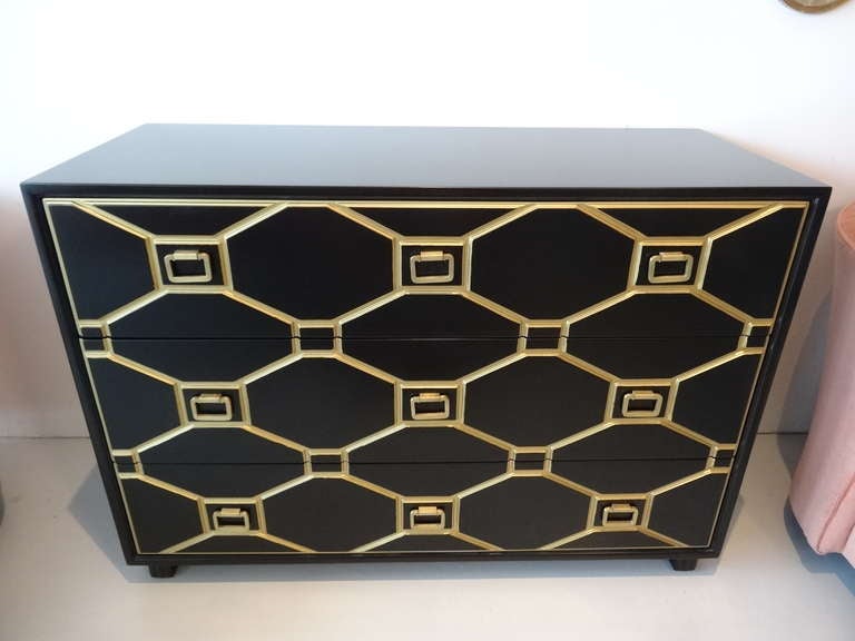 Exquisite chest of drawers by Dorothy Draper. Iconic geometric design decorate the front of the cabinet. 3 brass rings accent each one of the drawers.