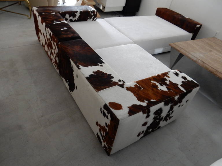 Incredible sofa. Endless combinations as the cow hide backs are removable, seats are chenille. If arranged as one long sofa it is 8' long and 49