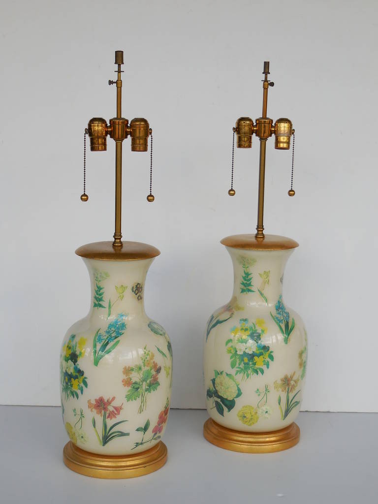 Beautiful pair of lamps by Mario Buatta for Frederick Cooper. Reverse decorated glass vessels mounted on giltwood bases and brass fittings.