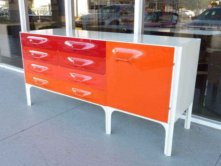 Raymond Loewy DF 2000 cabinet, by Doubinsky Freres, France, cabinet with six drawers and one door, molded plastic drawer fronts in shades of red and orange, DF 2000 label. Retains shelf behind door. 60.75