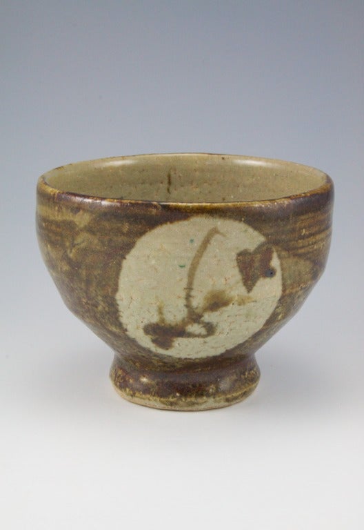 This tea bowl was first exhibited at Bonniers in New York City.  It has a classic brushwork design by Hamada, based on sugar cane decoration, and has an unusual out turned foot ring meant for winter tea bowls used in the traditional Japanese tea