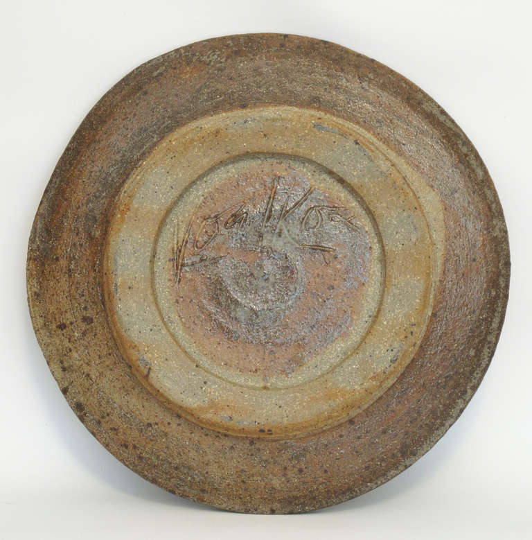 Peter Voulkos was one of the leading and most important mid-century artists in the United States. With this graphic plate, Voulkos used a stencil technique with layers of slip and glaze to design an abstract bird and its shadow. 10.5 in diameter.