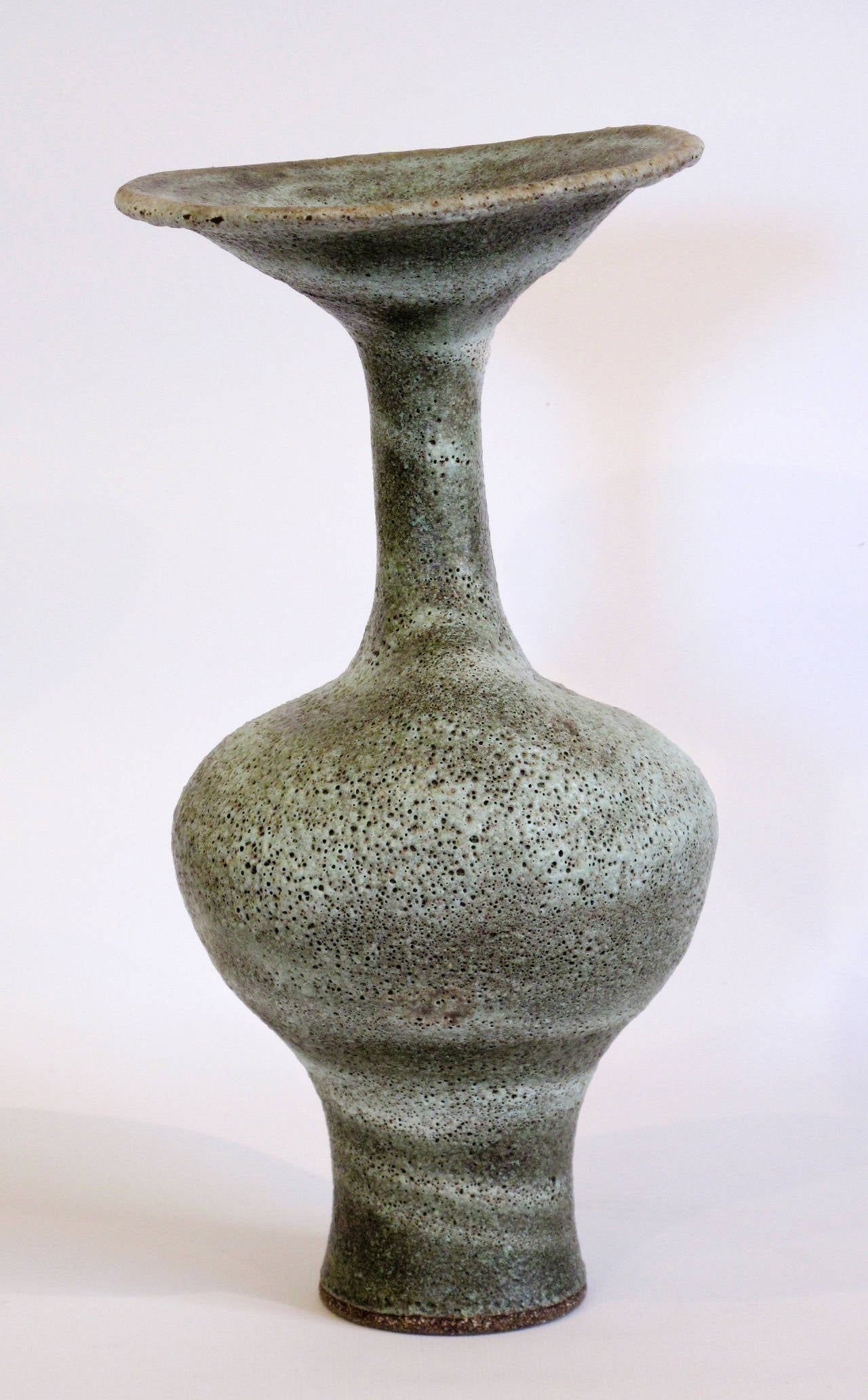 Lucie Rie is one the most important British artists in studio ceramics and craft. Along with Hans Coper, Rie lead studio ceramics into the modern era. To make forms this tall, Lucie assembled her vases in sections: The base and then the neck. This