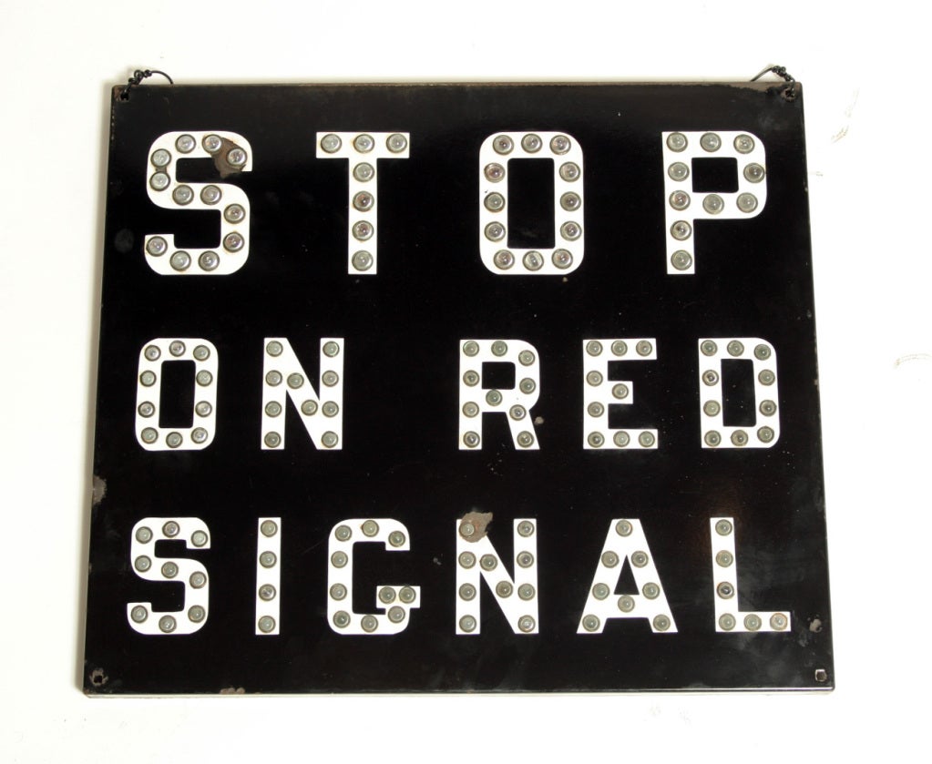 An authentic vintage railroad sign featuring clear half-round reflective glass 