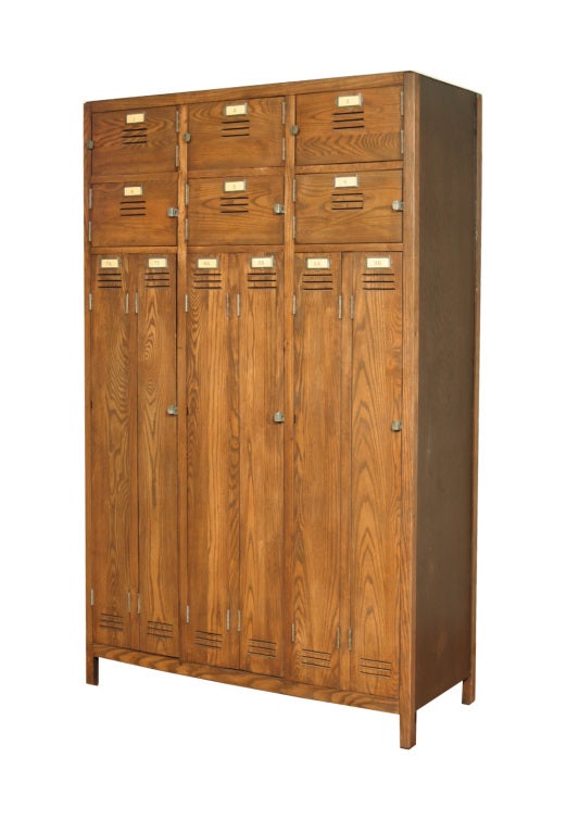 This bank of lockers has a solid oak front and has been restored to its original beauty without sacrificing any of its charm or vintage patina.  Each long locker has adjustable or removable shelves, and the labels on each door can be removed and