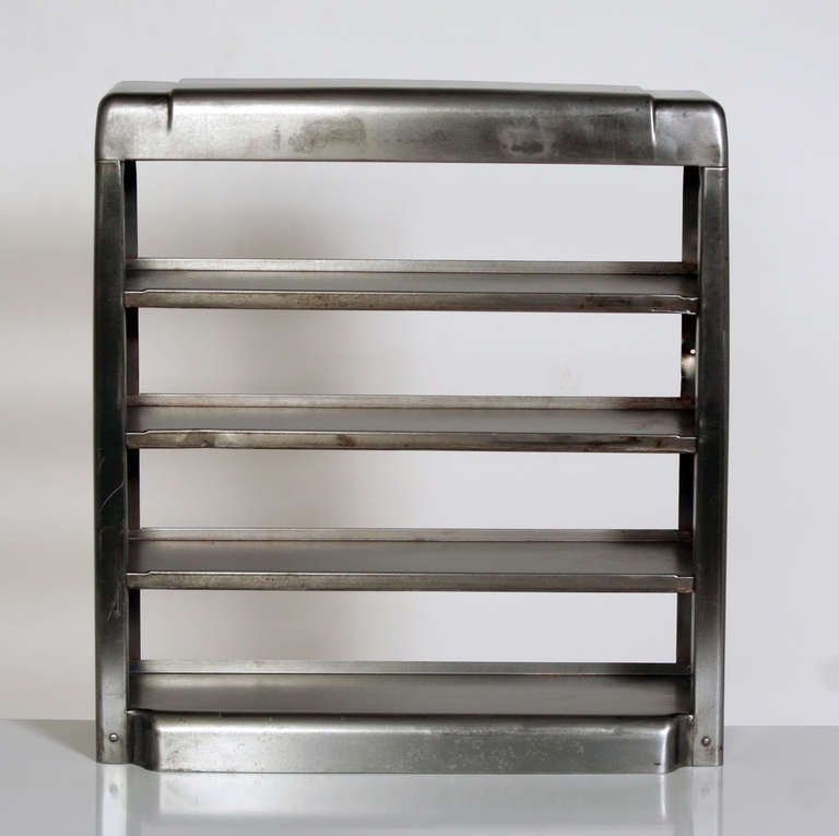 This set of shelves once sat atop the counter of a downtown diner, stocked with enticing baked goods to accompany steaming cups of coffee.  There are tabs on the back that would allow it to be hung on the wall, as well. We're not absolutely certain