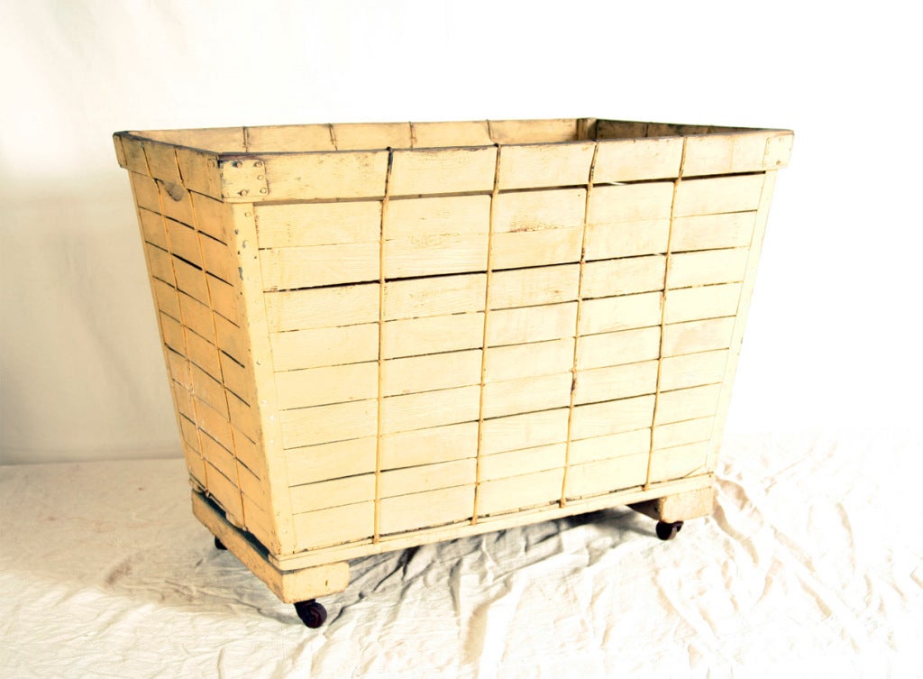 A roomy cart on casters with unusual woven wood slat sides.  Great character and charm for this industrial piece!