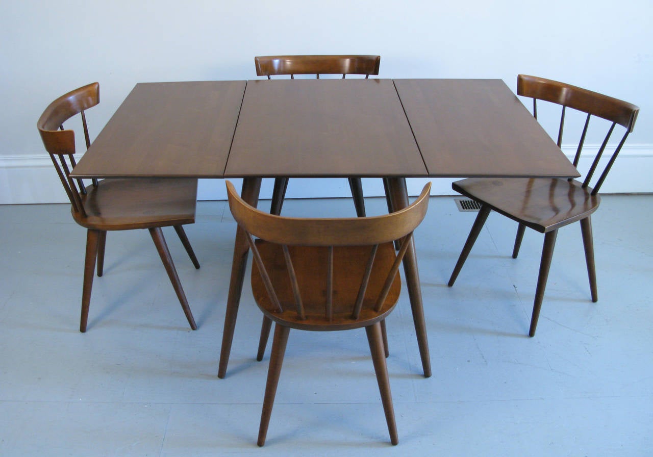 A great Paul McCobb dining drop-leaf table and four chairs.
The set is in it's original finish. Comfortable, sturdy and a wonderful design.