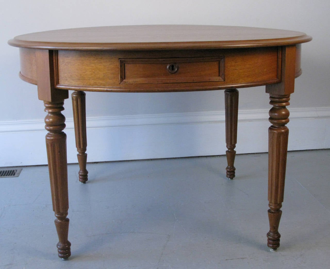 A very handsome and gutsy round walnut table from the Southern United States. The 1870s table has a very English William IV look to it and has a nice deep drawer. The table could be used for dining or center hall with it's 45