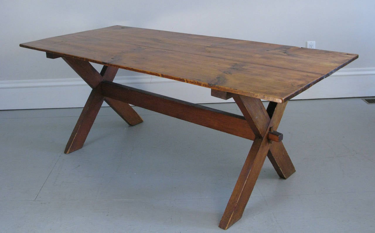 A great looking sawbuck table from the 1940s. Two beautiful old pine boards make up the top. Good size and nice and sturdy.