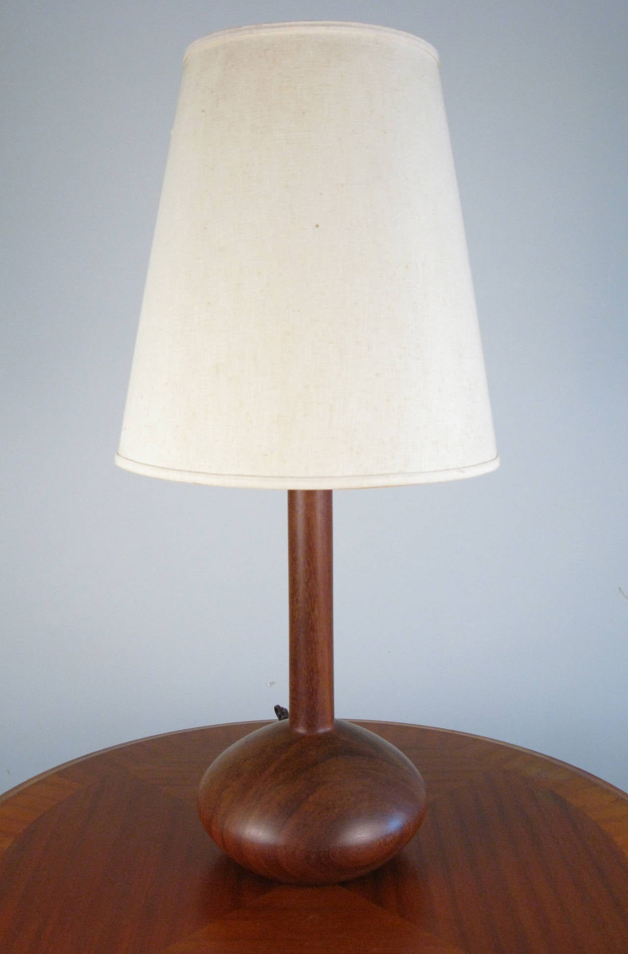 A simple and elegant mid-century table lamp with its original shade.