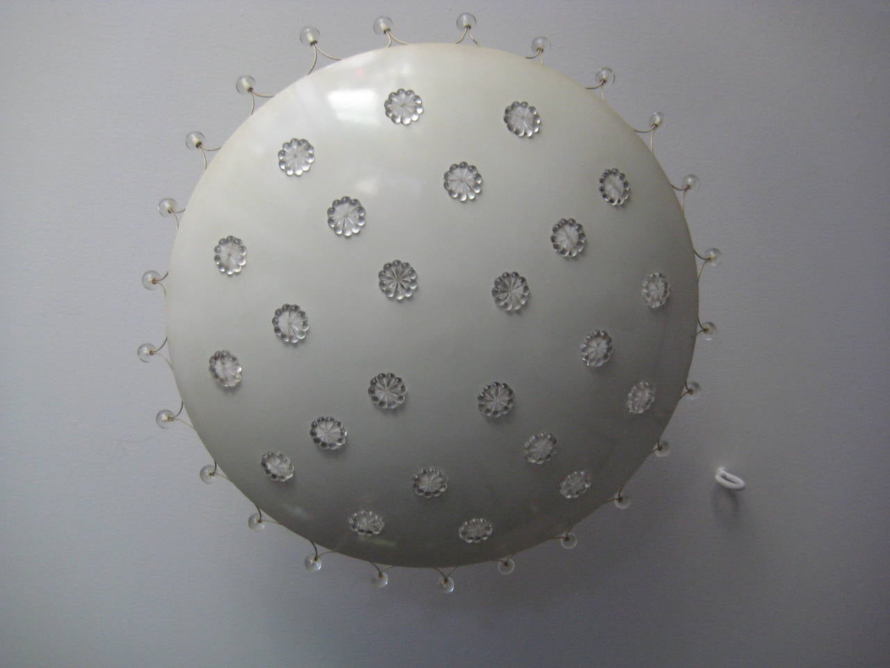 Convex white metal disk with glass decoration providing 
unique decorative details