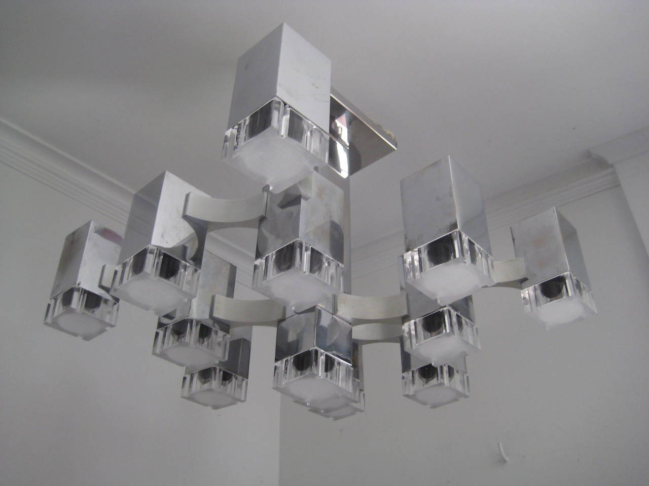 Sculptural chandelier consisting of 13 cube forms which illuminate from within.