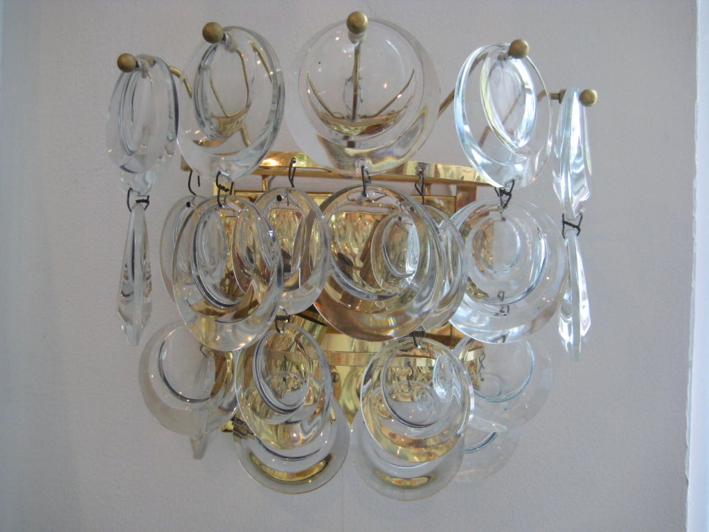 Molded and polished glass disks mounted on a gold platted armature.