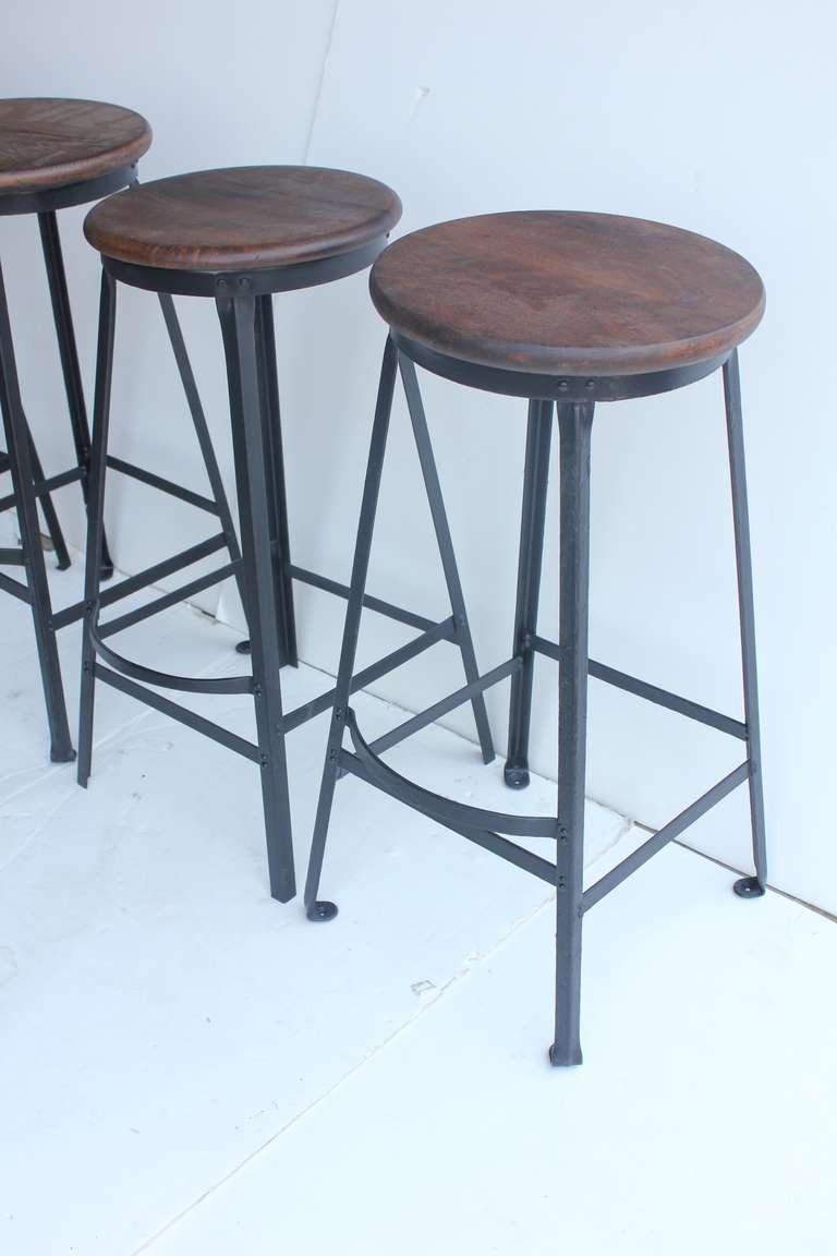 Set of four vintage original American industrial stools with wooden seats. Newly refinished. More available.