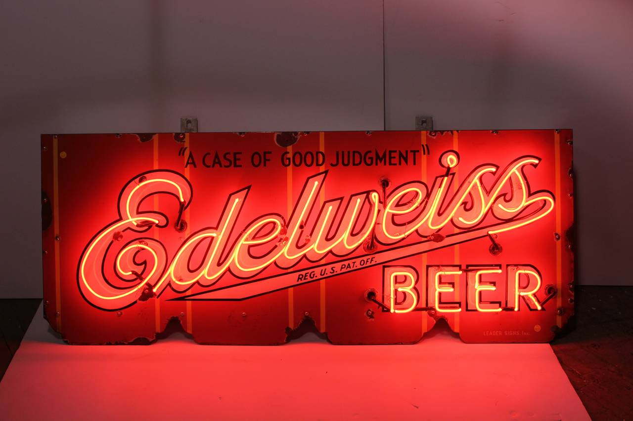 1930s porcelain advertising sign for "Edelweiss Beer a Case of Good Judgment" sign with a red neon.