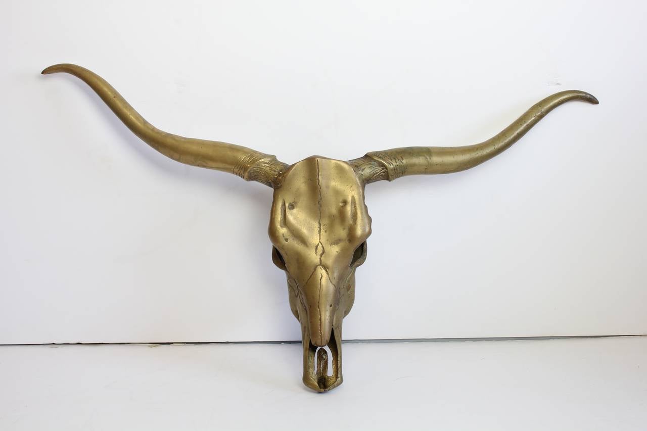 Stylish vintage solid brass longhorn skull wall sculpture. Hanger attached to the back of the skull.