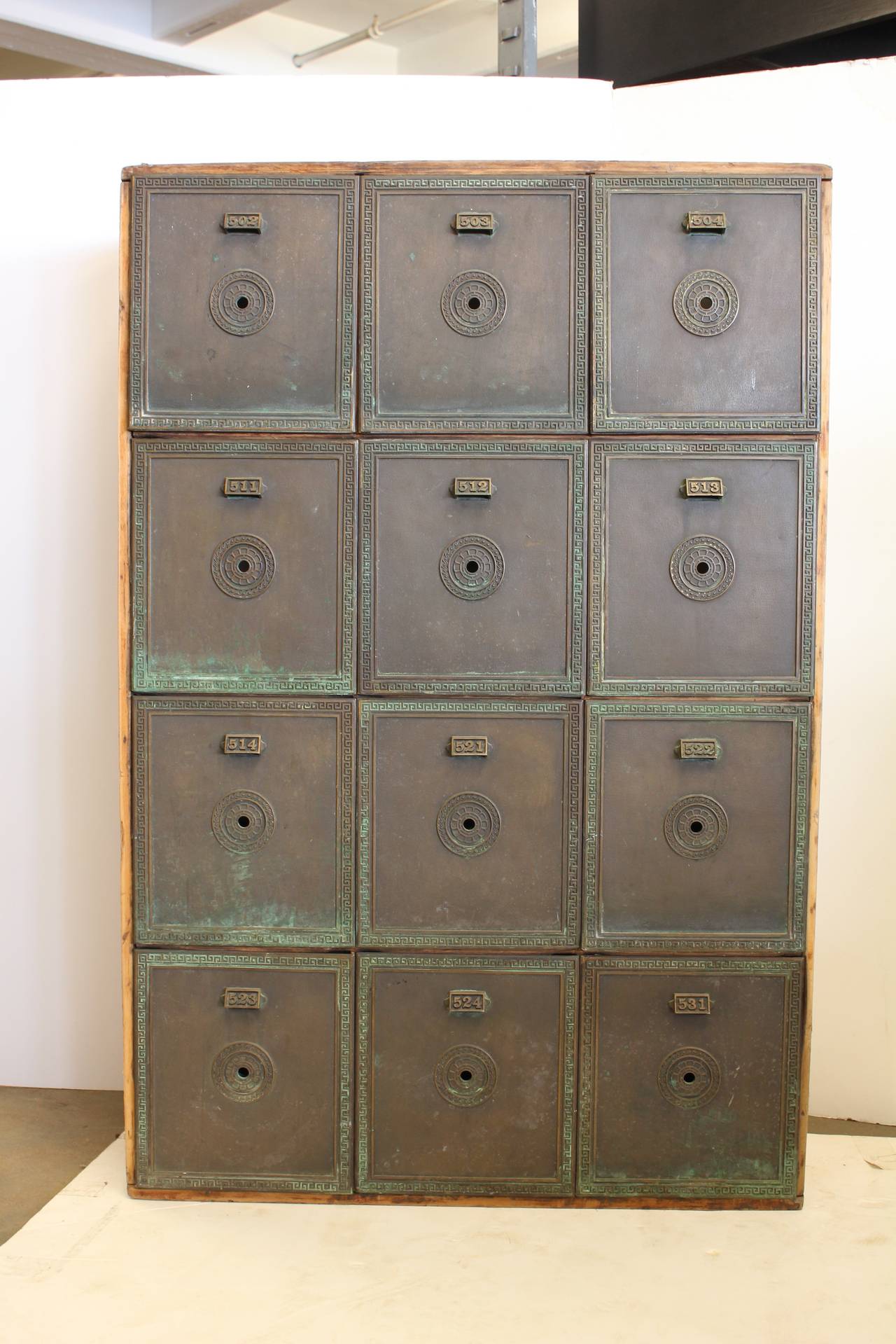 Great antique safety deposit box unit with wooden frame and bronze drawers.