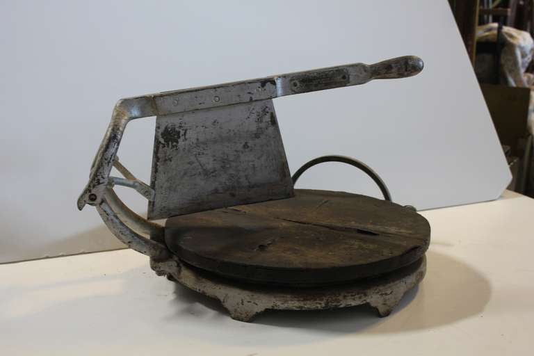 Antique deli cheese cutter with cast iron base and wood board by Computing Cheese Cutter Company.