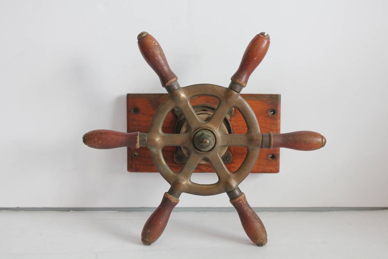 Vintage brass and wood boat steering wheel.